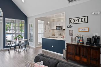 A kitchen with a coffee sign on the wall.